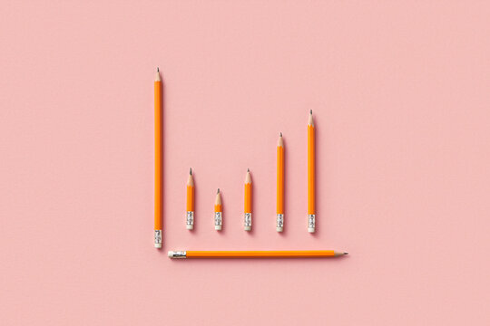 Pencils arranged as graph on pink background
