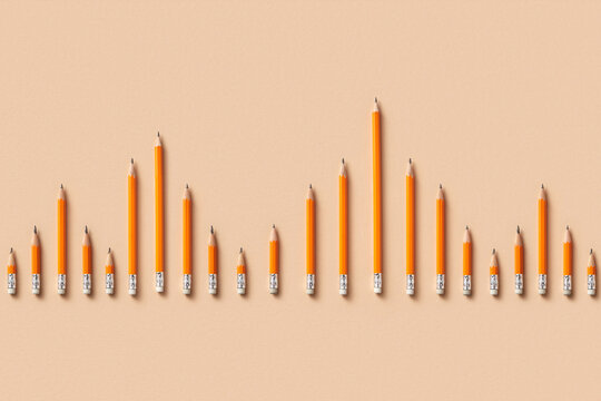 Top view of orange pencils forming chart bars