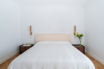 Minimalist bedroom with abstract art above the bed