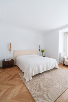 Stylish bedroom with textured carpet and modern furniture