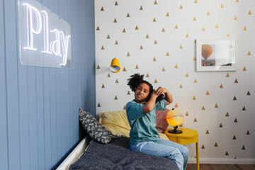 Young girl doing hairstyle in modern bedroom