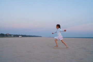 happy kid running on the beach