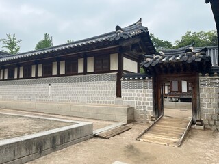 Traditional Korean Palace Wall and Wooden Gate Entrance with Tiled Roof