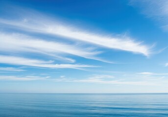 Vast blue ocean under a sky with wispy white clouds, creating a serene and peaceful natural landscape