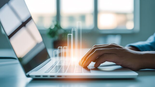 Close up of hands typing on a laptop with glowing financial graph overlay