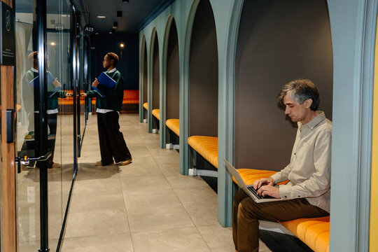 Modern Workspace Scene with Professionals Engaged in Tasks