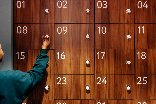 Hand of Person Unlocking Wooden Locker 