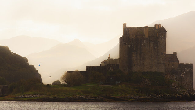 Eilean Donan Castle on Loch Duich near Dornie in the Scottish Highlands shrouded in mist and moody atmospheric light.