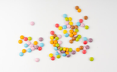 Scattered small candies isolated. Colorful dragees, multicolored glazed chocolate buttons
