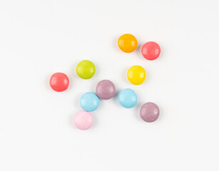Fototapeta na wymiar Scattered small candies isolated. Colorful dragees, multicolored glazed chocolate buttons