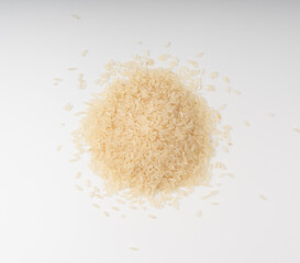 White parboiled rice grains. Dry uncooked ponni rice, small organic basmati
