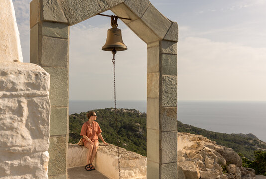 Woman Sitting at Hilltop Castle Of Monolithos