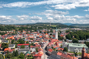 Picturesque historic center and panoramic aerial views of Żywiec, Poland—a charming town by the Beskid mountains and Żywiec Lake. Old town, cathedral tower and a scenic landscape on a summer day.