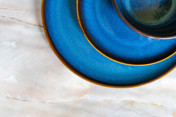 An abstract image of dark blue ceramic dishes. 