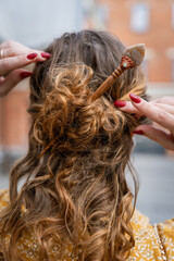 Obraz premium Styling Hair with Wooden Hairpin for a Casual Updo