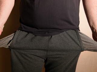 The concept of no money and poverty. A man turns his pockets inside out and finds nothing