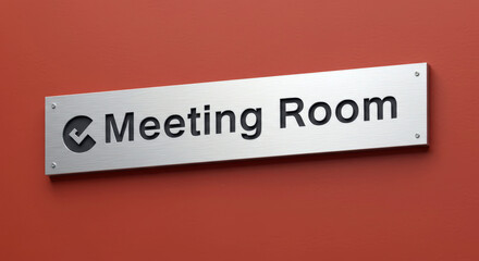 Silver Meeting Room Sign on a Textured Orange Wall Highlighting Professional Business Environment and Conference Venue Accessibility with Modern Corporate Design Elements
