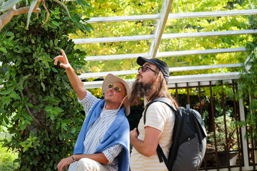 Tourists Pointing Inside Botanical Garden