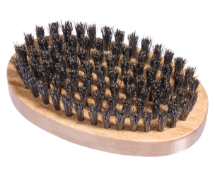 Wooden brush with dense natural black bristles, oval shape. Isolated background