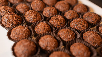 Traditional Brazilian brigadeiro chocolate truffles in elegant presentation. Perfect for dessert tables, party favors, and gourmet food photography with rich cocoa flavor