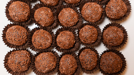 Traditional Brazilian brigadeiro chocolate truffles in elegant presentation. Perfect for dessert tables, party favors, and gourmet food photography with rich cocoa flavor