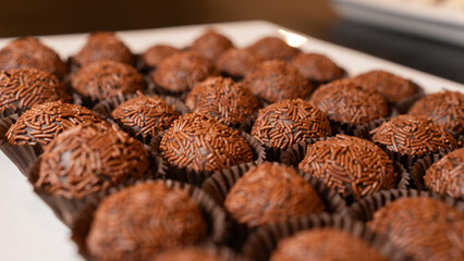 Traditional Brazilian brigadeiro chocolate truffles in elegant presentation. Perfect for dessert tables, party favors, and gourmet food photography with rich cocoa flavor