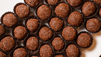 Traditional Brazilian brigadeiro chocolate truffles in elegant presentation. Perfect for dessert tables, party favors, and gourmet food photography with rich cocoa flavor