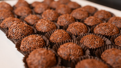 Traditional Brazilian brigadeiro chocolate truffles in elegant presentation. Perfect for dessert tables, party favors, and gourmet food photography with rich cocoa flavor