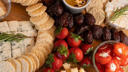 Elegant gourmet cheese board with fresh fruits, dried fruits, honey, nuts and artisanal snacks. Perfect for wine nights, brunch or luxury entertaining
