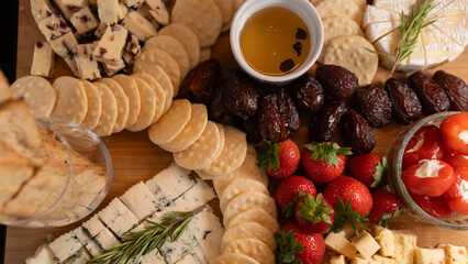 Elegant gourmet cheese board with fresh fruits, dried fruits, honey, nuts and artisanal snacks. Perfect for wine nights, brunch or luxury entertaining