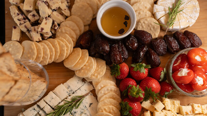 Elegant gourmet cheese board with fresh fruits, dried fruits, honey, nuts and artisanal snacks. Perfect for wine nights, brunch or luxury entertaining