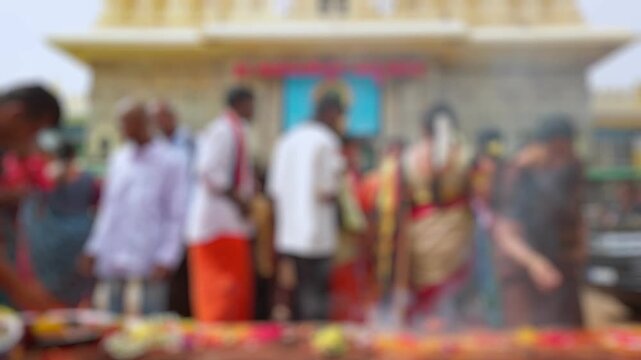Bokeh view of devotees visit Sri Chamundeshwari Temple, located on Chamundi Hills near Mysore, India. Blurred background footage.