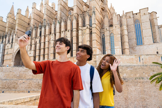 Students taking selfie in front of palma cathedral, mallorca