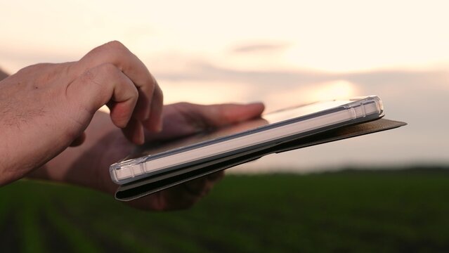 Agriculture, Close-up of farm worker with tablet, Precision agriculture concept, Female farmer checking crops, Tablet in use on plantation, Hands holding technology in nature, Field management with