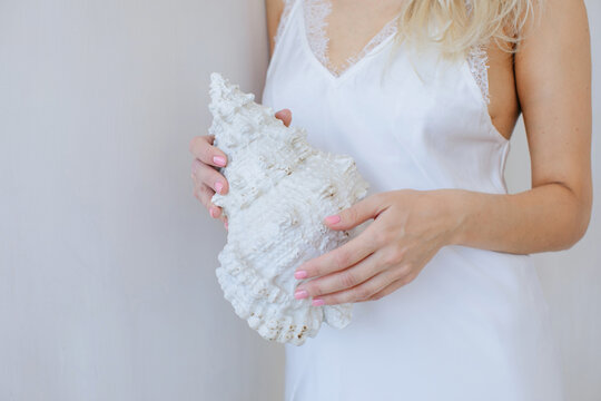 Anonymous woman holds big shell 