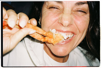 Woman Eating Crab Legs
