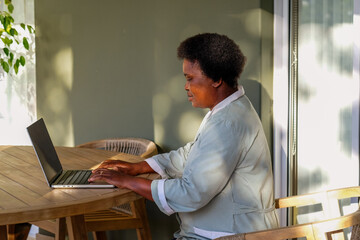 Woman Working at Dining Table
