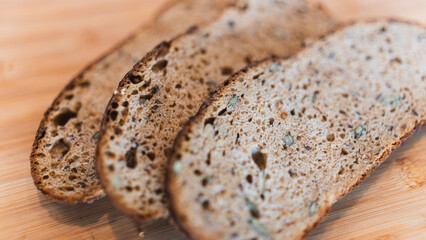 Nutritious dark bread packed with seeds and whole grains. Rustic homemade loaf perfect for healthy eating, food photography, and artisanal bakery content