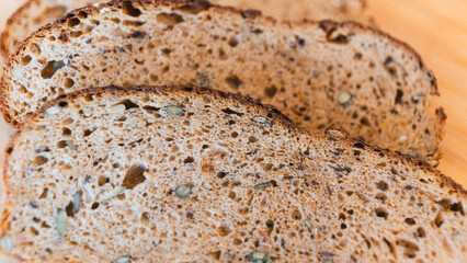 Nutritious dark bread packed with seeds and whole grains. Rustic homemade loaf perfect for healthy eating, food photography, and artisanal bakery content