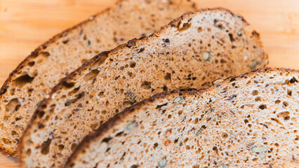 Nutritious dark bread packed with seeds and whole grains. Rustic homemade loaf perfect for healthy eating, food photography, and artisanal bakery content
