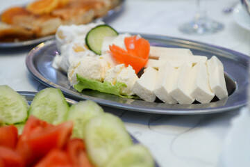 a plate with finely chopped cheese, two balls of cream and paprika in sour cream. Garnished with carrots and ready to eat