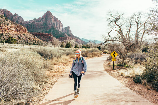 Woman hiking on a trail among mountains