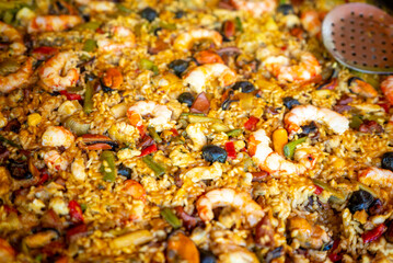 The vibrant and colorful texture of a freshly cooked paella with shrimp and mussels gastronomy concept