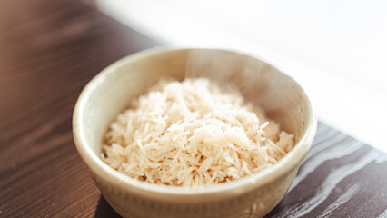 Fluffy white basmati rice steaming fresh from the pot. Perfectly cooked grains for food photography, recipe blogs, and Asian/Indian cuisine content