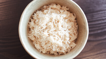 Fluffy white basmati rice steaming fresh from the pot. Perfectly cooked grains for food photography, recipe blogs, and Asian/Indian cuisine content