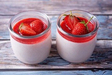Strawberry panna cotta with strawberry sauce and fresh strawberries