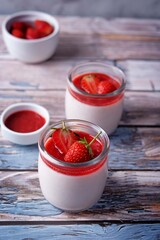 Strawberry panna cotta with strawberry sauce and fresh strawberries