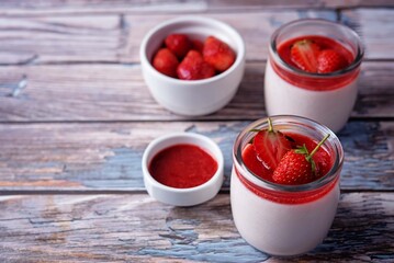 Strawberry panna cotta with strawberry sauce and fresh strawberries
