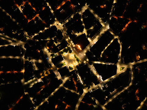 Nighttime Aerial View of a Lit Town