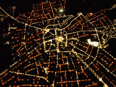 Nighttime Aerial View of a Lit Town